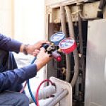 Technician is checking air conditioner ,measuring equipment for filling air conditioners.